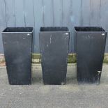 A collection of three large black painted garden pots,