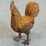 A rusted iron garden model of a hen,