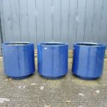 A collection of three blue painted circular garden pots,