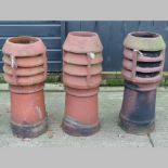 A collection of three terracotta chimney pots,