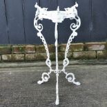 An ornate white painted brass plant stand,
