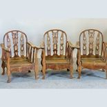 A set of three wooden garden armchairs