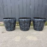 A collection of three black and silver painted garden pots,