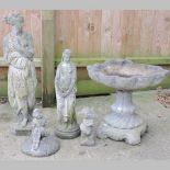 A reconstituted stone bird bath, 48cm tall, together with a collection of four garden figures,