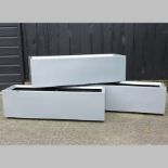 A collection of three silver painted garden troughs,