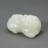 A CHINESE WHITE JADE LION PENDANT