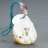 A CHINESE WHITE AND RUSSET JADE 'SQUIRREL AND GRAPES' PENDANT