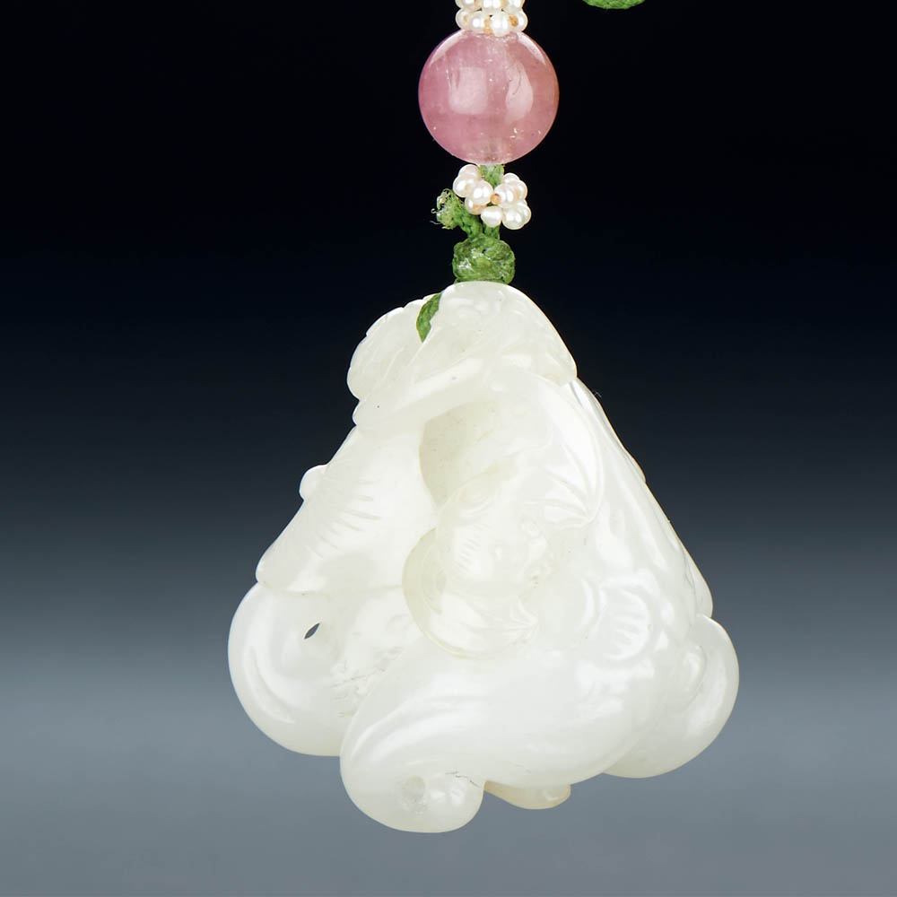 A CHINESE WHITE JADE 'BAT AND WATER CALTROPS' PENDANT