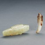 TWO CHINESE WHITE AND RUSSET JADE PENDANTS