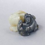 A CHINESE FINELY CARVED BLACK AND WHITE JADE 'TWO BADGERS' PENDANT