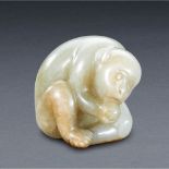 A CHINESE PALE CELADON AND RUSSET JADE CARVING OF 'MONKEY HOLDING PEACH'