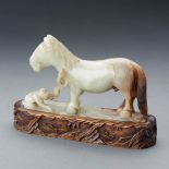 A CHINESE WHITE AND RUSSET JADE CARVING OF 'MONKEY AND HORSE'