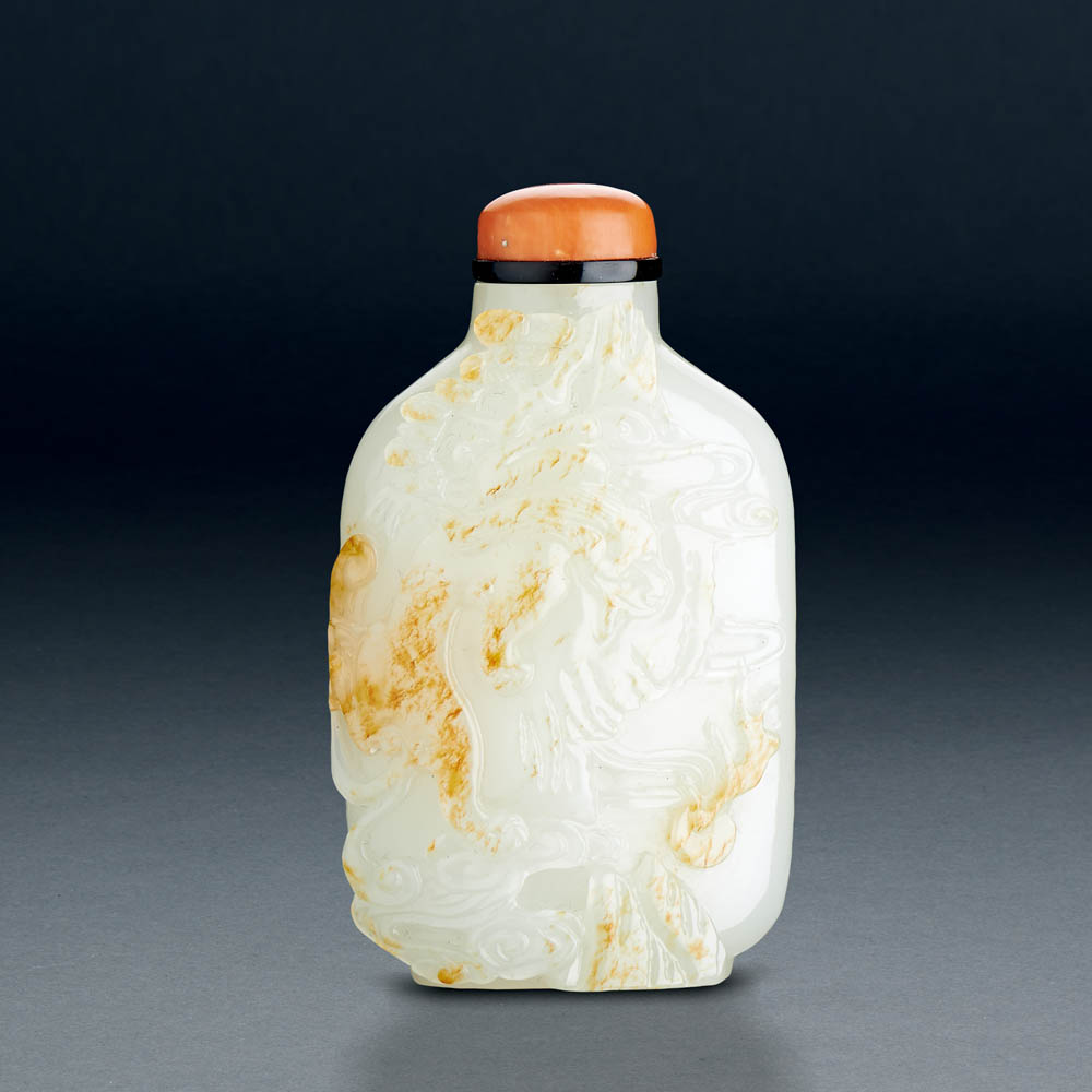A CHINESE WHITE AND RUSSET JADE 'DRAGON AND PHOENIX' SNUFF BOTTLE
