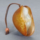 A CHINESE FINELY CARVED WHITE AND RUSSET JADE 'BEAUTY IN CLAM' PENDANT