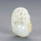 A CHINESE WHITE AND RUSSET JADE PENDANT