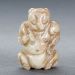 A CHINESE WHITE AND RUSSET JADE BEAR