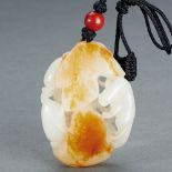 A CHINESE WHITE AND RUSSET JADE 'SQUIRREL AND PUMPKIN' PENDANT