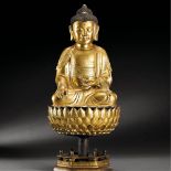 CHINA, MING DYNASTY (1368-1644) A GILT-BRONZE FIGURE OF VAIROCANA WITH STAND Figure: H 21 cm. (8 1/4