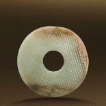 HAN DYNASTY (206 BC-AD 220) A WHITE AND RUSSET JADE DISC, BI D 9.2 cm. (3 5/8 in.) T 0.4 cm. 漢