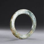 LIANGZHU CULTURE (CIRCA 3400-2250 BC) A CELADON JADE DISC, YUAN L 9.4 cm. (3 3/4 in.) T 0.9 cm