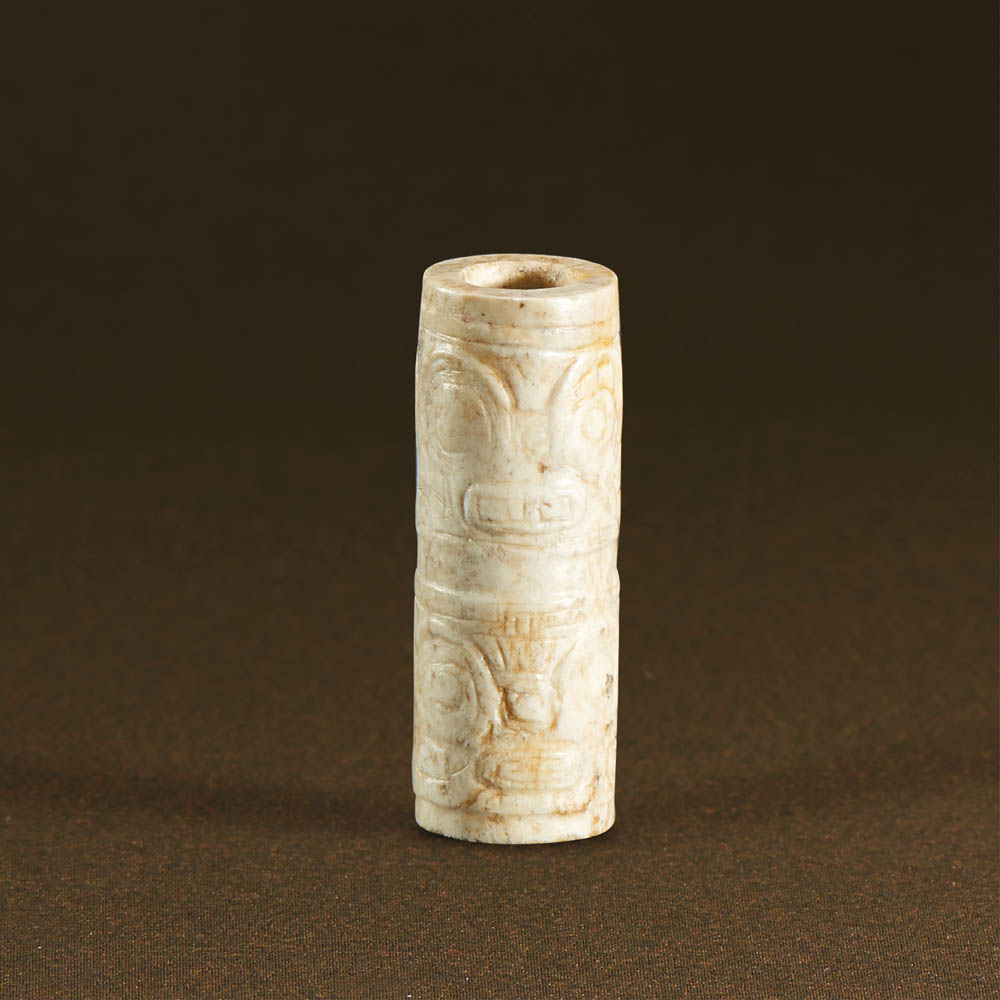 LIANGZHU CULTURE (CIRCA 3400-2250 BC) AN ARCHAIC JADE TUBE, LEZI L 2.9 cm. (1 1/8 in.) 良渚文化 獸面紋玉勒