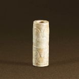 LIANGZHU CULTURE (CIRCA 3400-2250 BC) AN ARCHAIC JADE TUBE, LEZI L 2.9 cm. (1 1/8 in.) 良渚文化 獸面紋玉勒