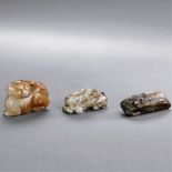 MING DYNASTY (1368-1644) A GROUP OF THREE RUSSET JADE BEAST PENDANTS AND FITTING  The largest: L 5.4