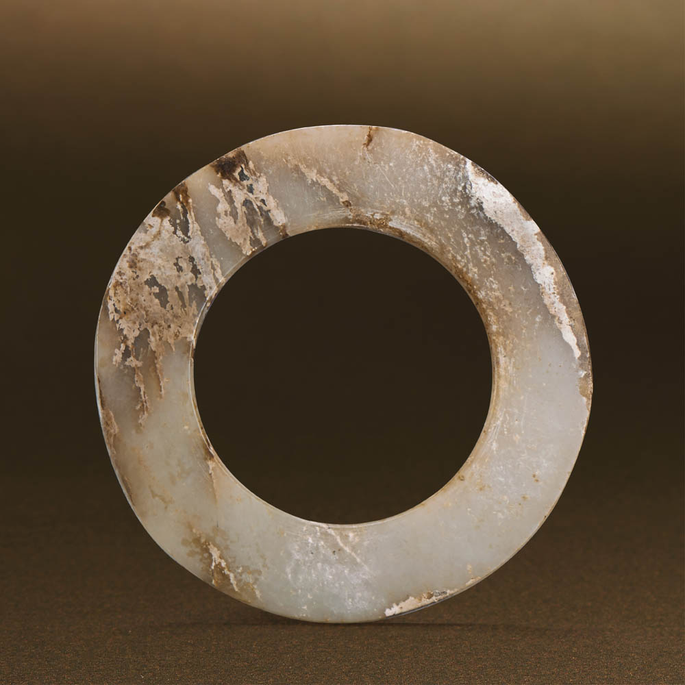 WESTERN ZHOU (CIRCA 1100-771 BC) AN UNEARTHED WHITE JADE DISC, YUAN D 10.7 cm. (4 1/4 in.) T 0.5 cm.