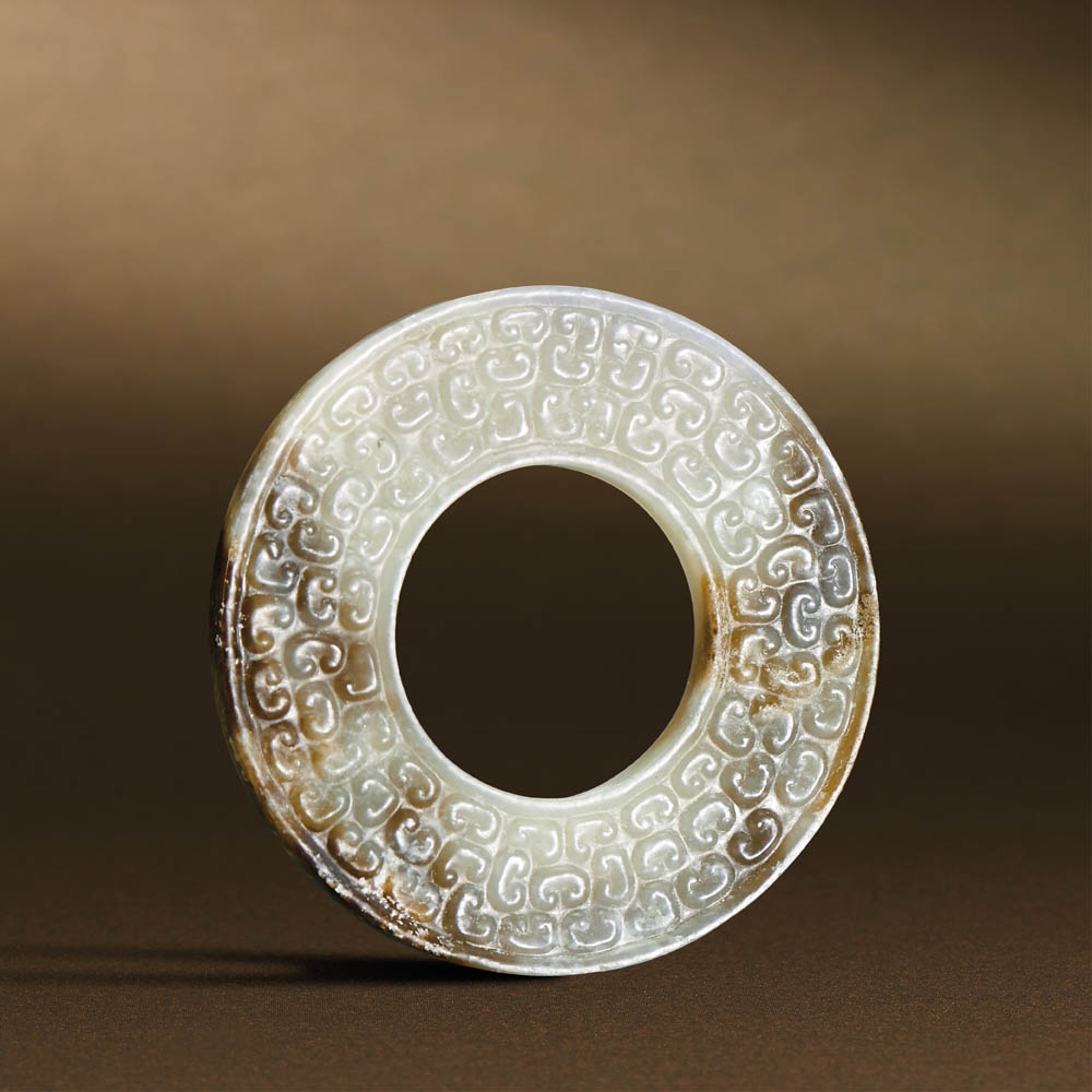 SPRING AND AUTUMN PERIOD (770-476 BC) A WHITE JADE DISC, YUAN D 6.5 cm. (2 1/2 in.) T 0.5 cm. 春秋