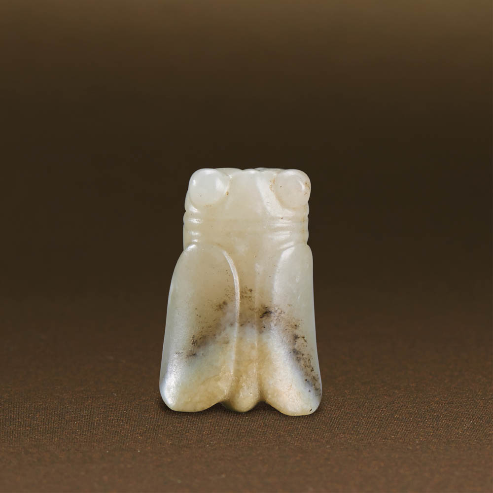 WESTERN ZHOU (CIRCA 1100-771 BC) A WHITE JADE CARVING OF A CICADA L 2.3 cm. (1 in.) 西周 白玉蟬形珮