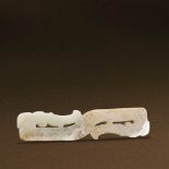 WARRING STATES PERIOD (475-221 BC) AN UNEARTHED WHITE JADE DOUBLE DRAGON PENDANT L 11.4 cm. (4 1/2