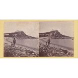 A Guernsey stereoview card depicting a Father and son onshore at L'Eree Bay during low tide, the