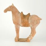 A Chinese terracotta horse in the manner of the Tang dynasty (700 AD), the broad equine figure in