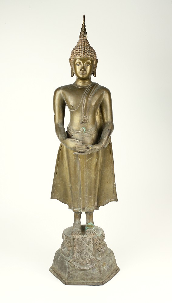 A Thai brass figure of Buddha 20th century, standing and holding an alms bowl, on a decorated