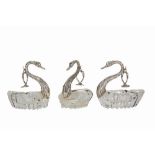 A set of three Continental silver and cut glass swan form ashtrays, import mark for London, 1986,