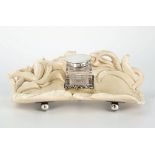 A carved ivory and silver ink stand, early 20th century, rectangular in form, the rear bearing a