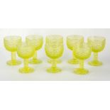 A set of eight pale green uranium pressed glass goblets, the cup bowls with raised dot work design