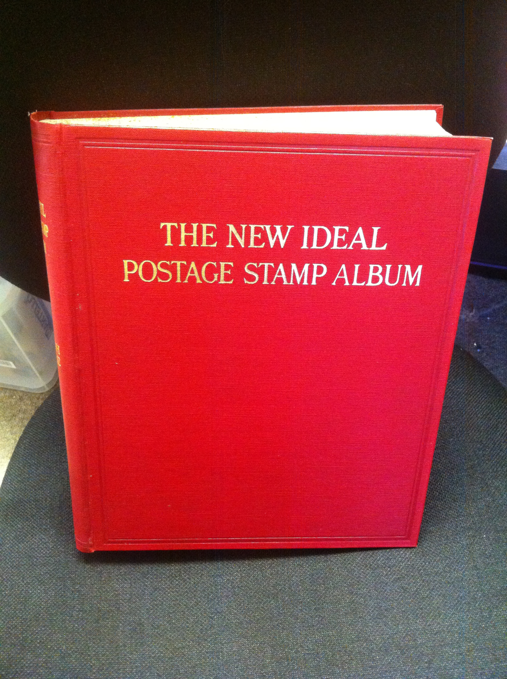 STAMP ALBUM : New Ideal album in original box & in superb condition with a splattering of stamps.