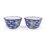 A PAIR OF CHINESE CANTON ENAMEL WINE CUPS, 19TH CENTURY with a blue ground decorated with flying