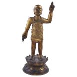 A GILT BRONZE FIGURE OF THE INFANT BUDDHA, MING DYNASTY, 16TH/17TH CENTURY depicted standing on a