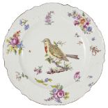 A CHELSEA PLATE, CIRCA 1755 brightly painted with a vignette of a bird perched on a branch framed by