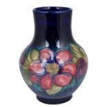 A MOORCROFT 'CLEMATIS' BALUSTER VASE, CIRCA 1950 tube lined with flowers against a mottled deep blue