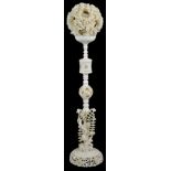 A CHINESE IVORY PUZZLE BALL ON STAND, PROBABLY CANTON, LATE 19TH CENTURY the ball pierced and