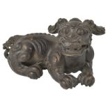 A CHINESE BRONZE BUDDHIST LION SCROLL WEIGHT, QING DYNASTY (1644-1908) recumbent figure with flowing