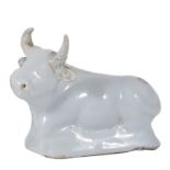 A SMALL Dutch Delft FIGURE OF A recumbent cow, 18th century in the white 9cm long, restored