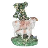 A DERBY PORCELAIN GROUP OF A COW AND CALF, CIRCA 1800 standing before a flowering tree, on an oval