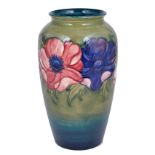 A MOORCROFT 'ANEMONE' SLENDER OVOID VASE, CIRCA 1950 tube lined with purple and mauve flowers