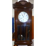 A 1930's mahogany cased chiming wall clock