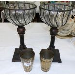 Two Middle Eastern silvered metal beakers; a pair of painted metal stands with glass bowls