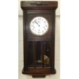 A 1930's oak cased chiming wall clock
